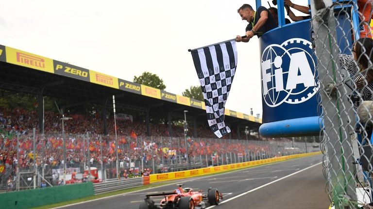 Ferrari driver Charles Leclerc of Monaco crosses the finish line...