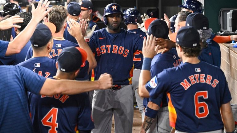 Houston Astros Yordan Alvarez, celebrates in the dugout after hitting...