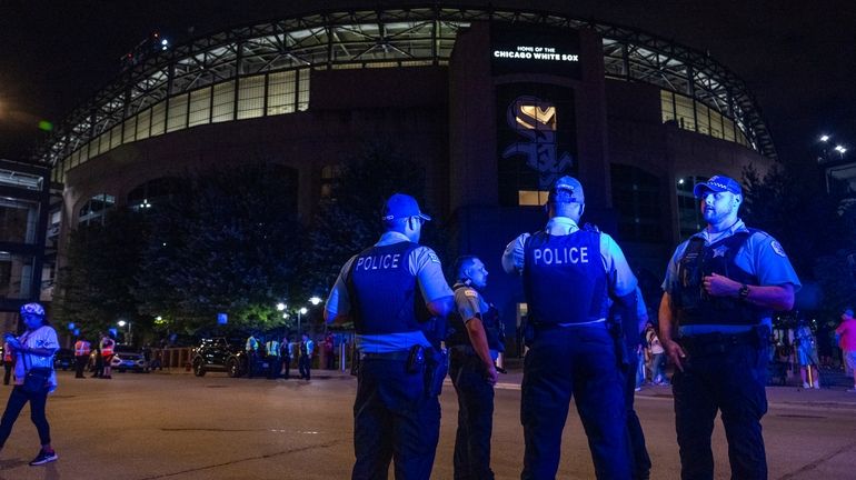 Chicago police officers respond to a shooting during a White...