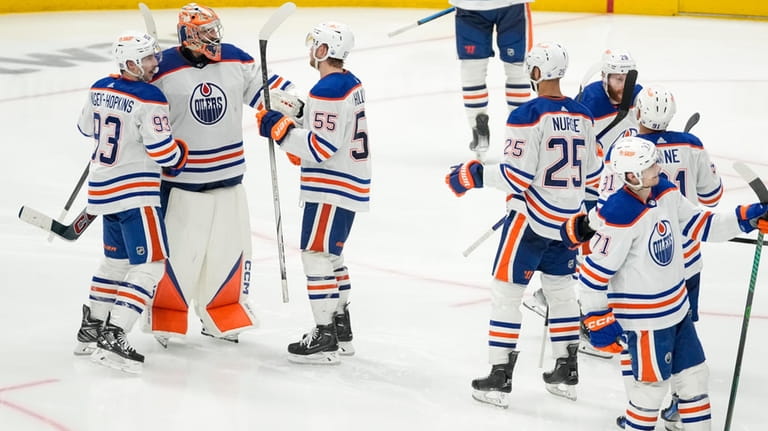 Edmonton Oilers goaltender Stuart Skinner, second from left, celebrates with...