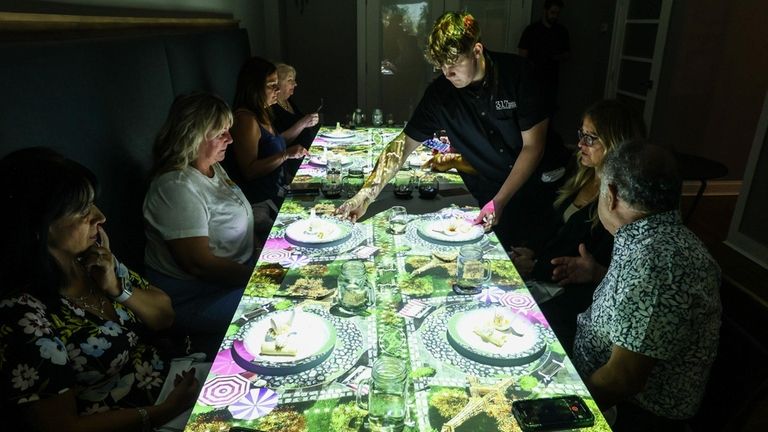 Diners watch the show projected onto their table as 317...