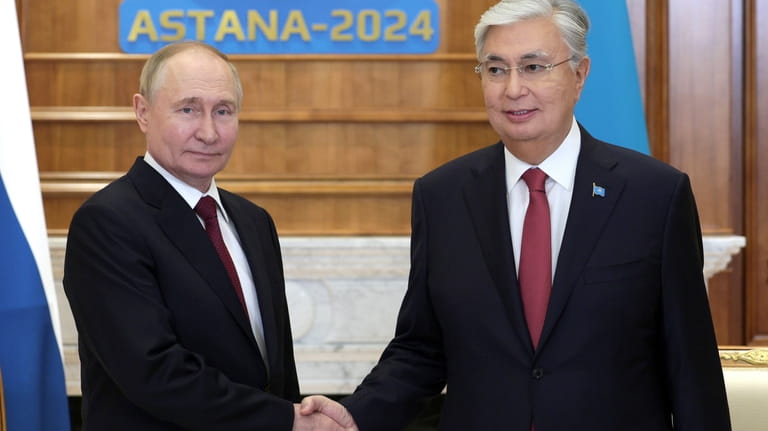 Russian President Vladimir Putin, left, listens to Kazakhstan's President Kassym-Jomart...