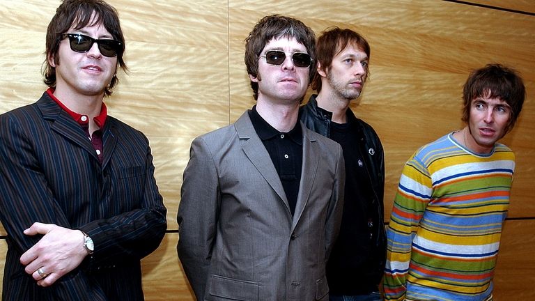 Members of British rock band Oasis pose for photos ahead...