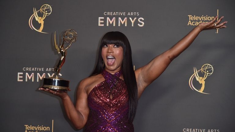 Angela Bassett poses with her award for outstanding narrator for...