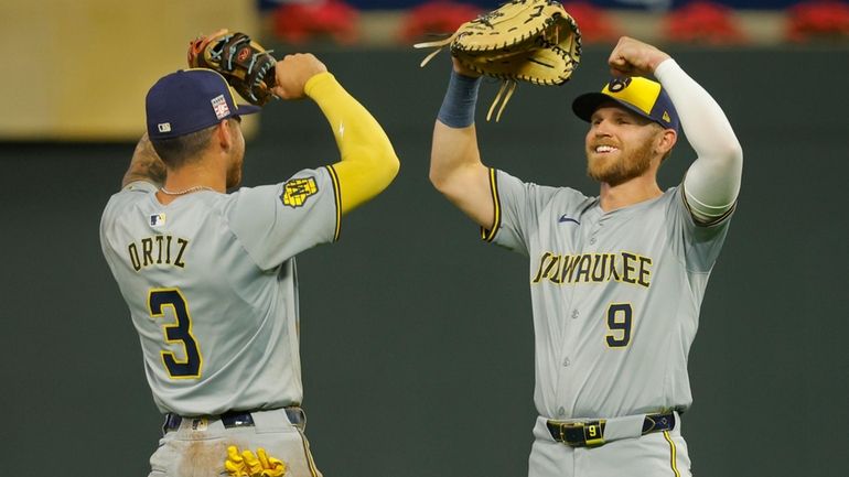 Milwaukee Brewers third baseman Joseph Ortiz (3) and first baseman...