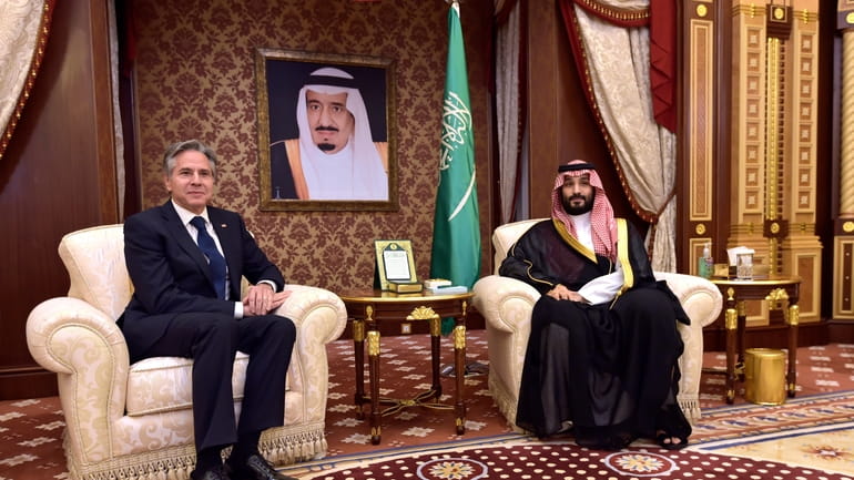 Saudi Arabia's Crown Prince Mohammed bin Salman, left, meets with...