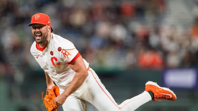 San Francisco Giants pitcher Robbie Ray reacts after throwing during...