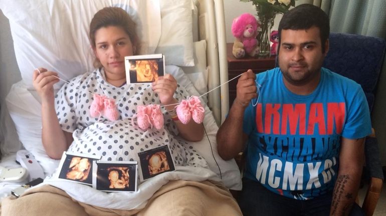 Silvia Hernandez and husband Raul Torres of Texas hold up...