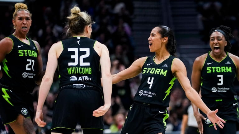 Seattle Storm center Mercedes Russell (21), guard Sami Whitcomb (32),...