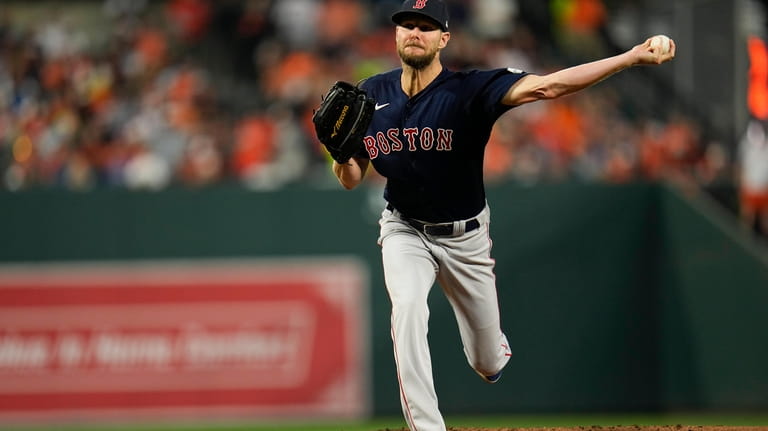 Boston Red Sox starting pitcher Chris Sale throws to the...