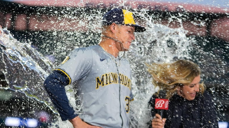 Milwaukee Brewers pitcher Tobias Myers is doused with water after...