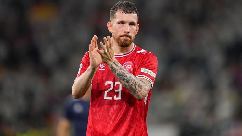 Denmark's Pierre-Emile Hojbjerg applauds fans after a round of sixteen...