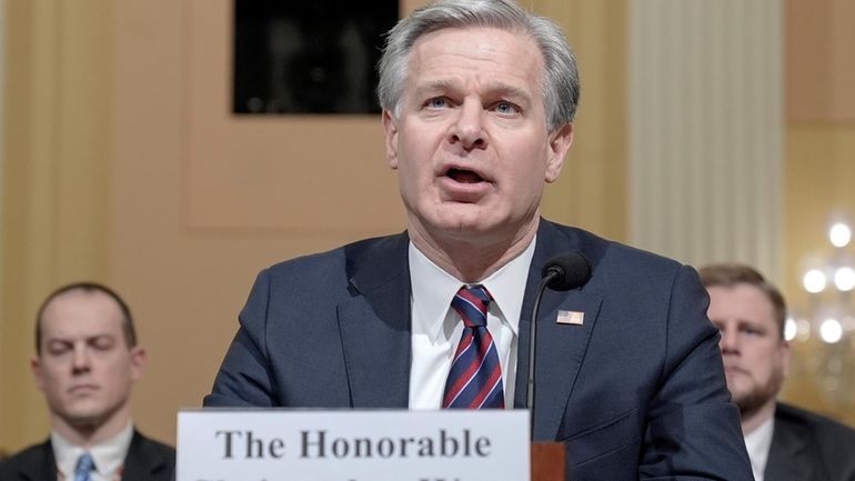 FBI Director Christopher Wray, center, testifies during a House Select...