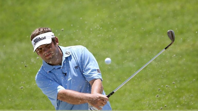 Matt Dobyns hits a bunker shot during a practice round...