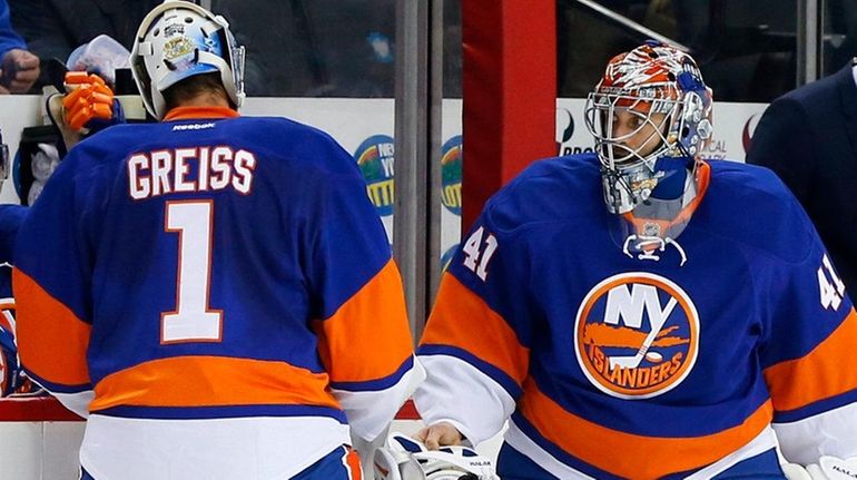 Jaroslav Halak #41 of the New York Islanders replaces Thomas...