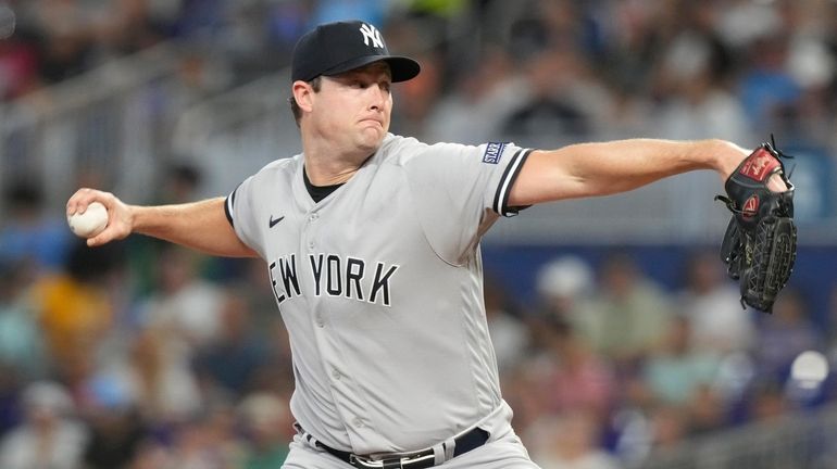 New York Yankees starting pitcher Gerrit Cole aims a pitch...