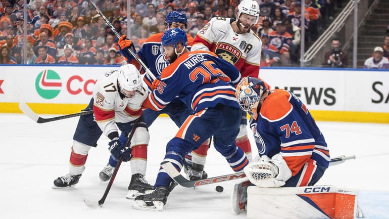 Florida Panthers' Evan Rodrigues (17) is stopped by Edmonton Oilers...