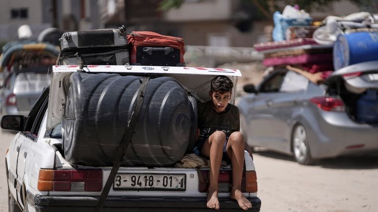 A Palestinian child rides in the trunk of a car...