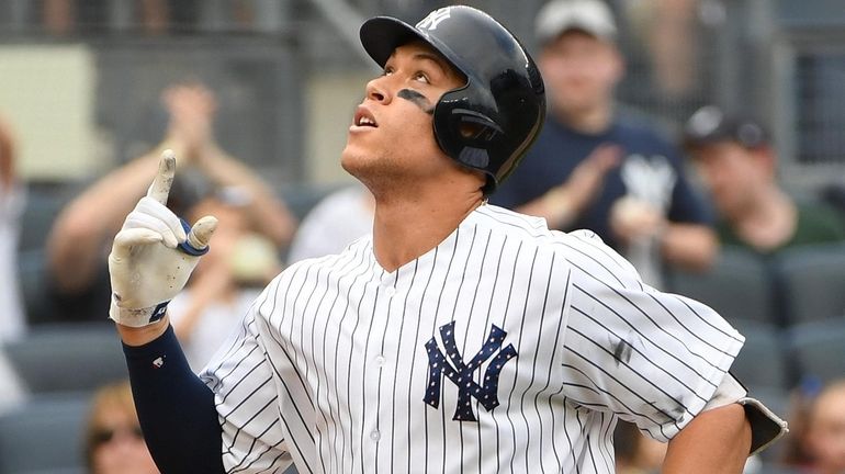 Yankees rightfielder Aaron Judge reacts as he scores on his...