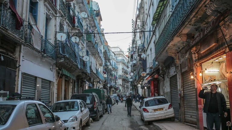 People walk near the Kasbah of Algiers, a UNESCO world...