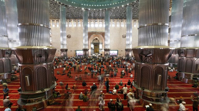 Muslim men leave after Friday prayers at Istiqlal Mosque in...