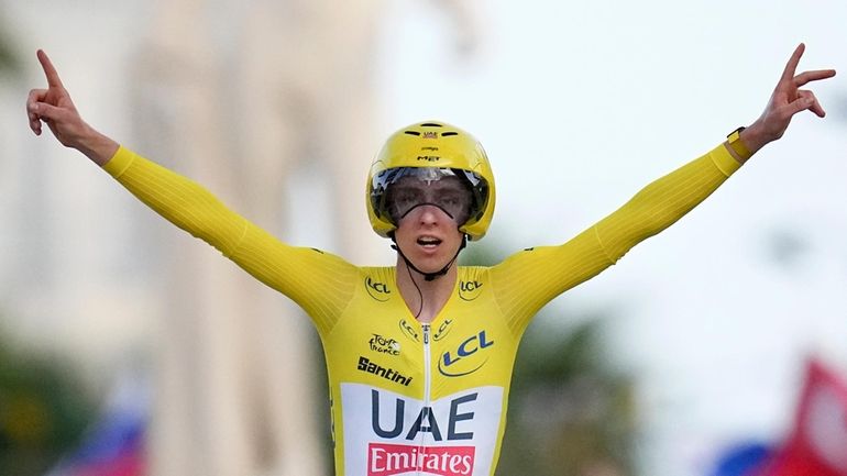 Tour de France winner Slovenia's Tadej Pogacar celebrates as he...