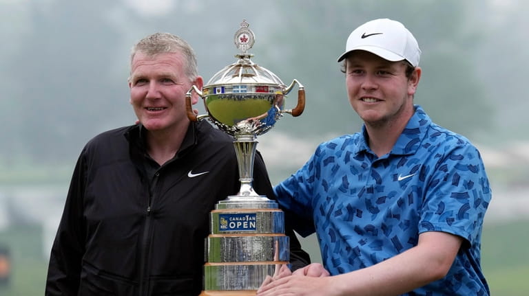 Scotland's Robert MacIntyre, right, and his father and caddie, Dougie...