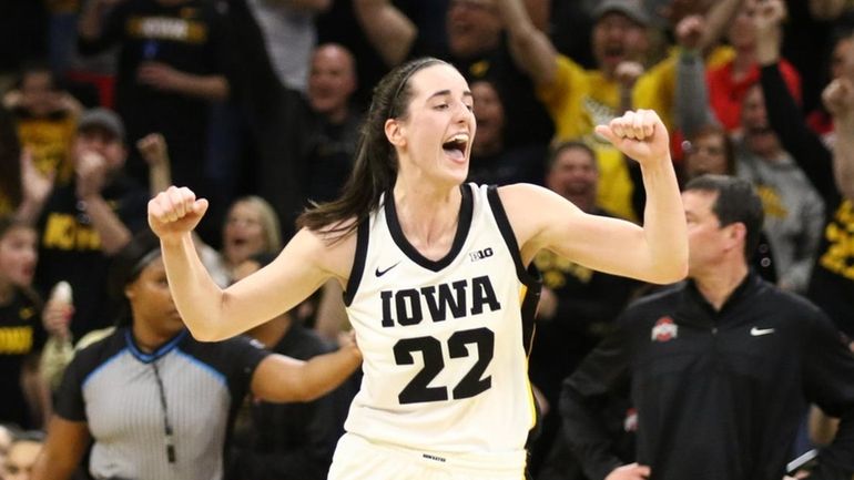 Guard Caitlin Clark #22 of the Iowa Hawkeyes celebrates after...