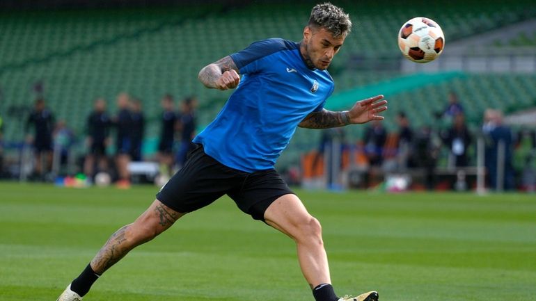 FILE -Atalanta's Gianluca Scamacca heads the ball during a training...