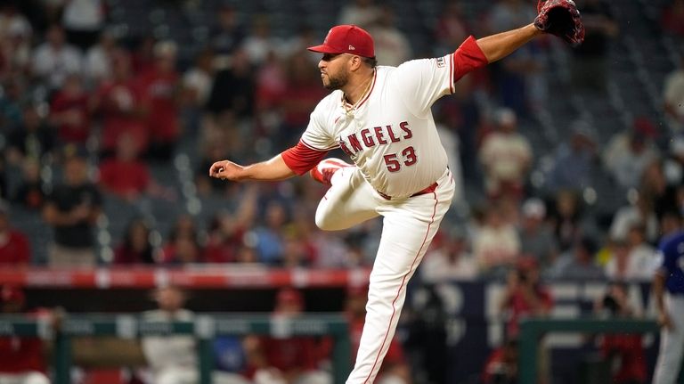 Los Angeles Angels relief pitcher Carlos Estevez throws to the...