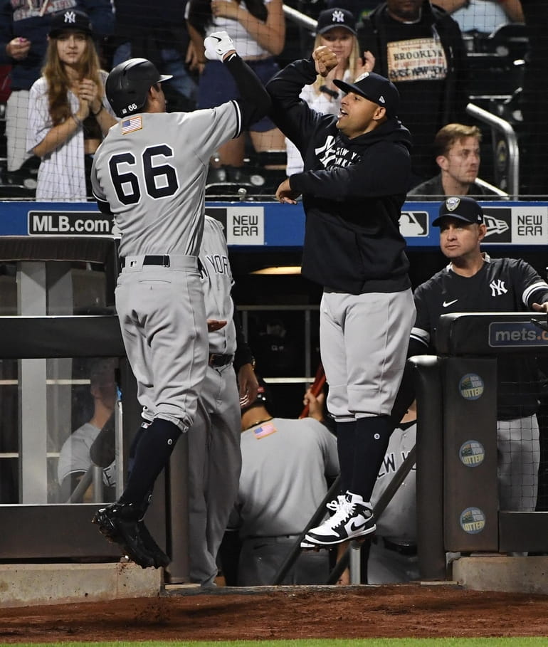 New York Yankees first baseman Anthony Rizzo looks on in an NYPD hat  against the New York Mets during the seventh inning of a baseball game on  Saturday, Sept. 11, 2021, in