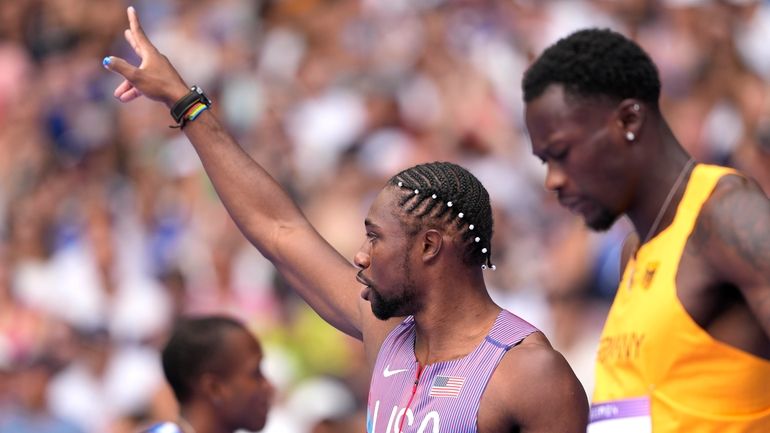 Noah Lyles, of the United States, gestures ahead of his...