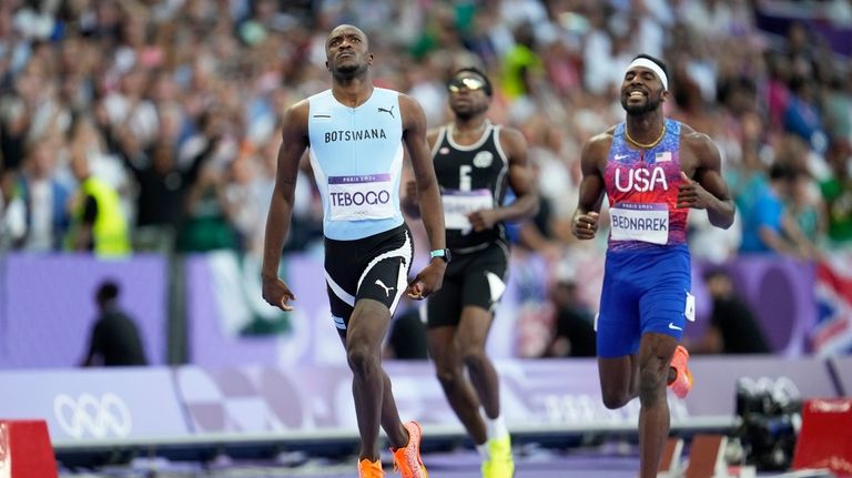 Letsile Tebogo, of Botswana, reacts after winning the gold medal...