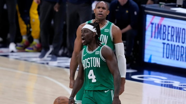 Boston Celtics guard Jrue Holiday (4) celebrates with teammate center...