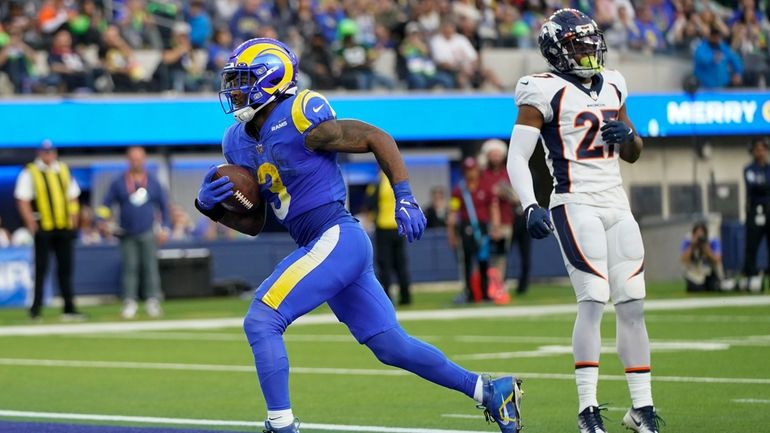 Los Angeles Rams running back Cam Akers scores past Denver...