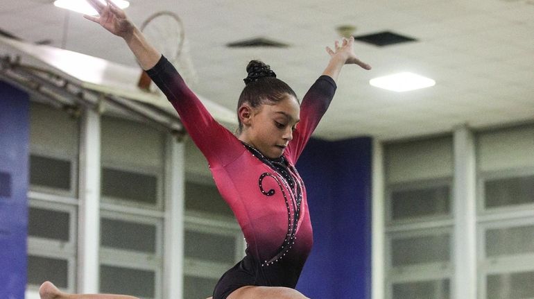 Jenna Kolberg of Syosset competes on the bar at the...