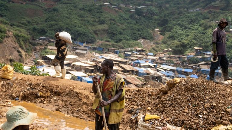 Gold miners at work in the town of Kamituga, in...