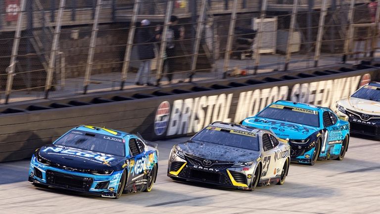 Corey LaJoie (7) leads Bubba Wallace (23) and Ross Chastain...