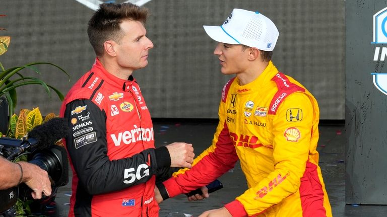 Alex Palou, right, is congratulated by Will Power after Palou...