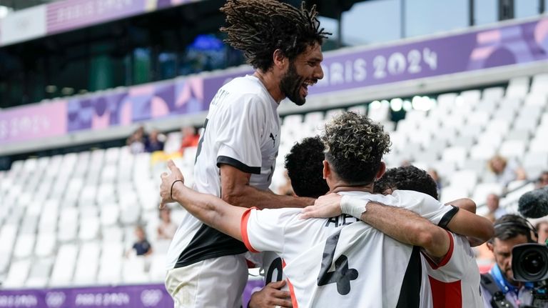 Egypt's Ibrahim Adel is congratulated after scoring his side's opening...