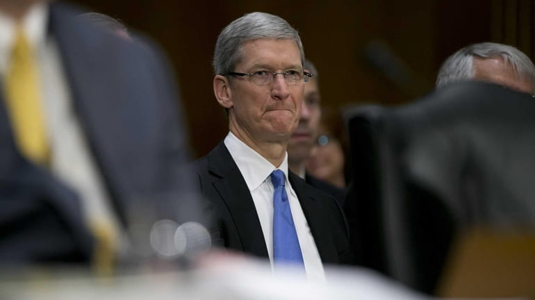 Tim Cook, chief executive officer of Apple Inc., arrives to...