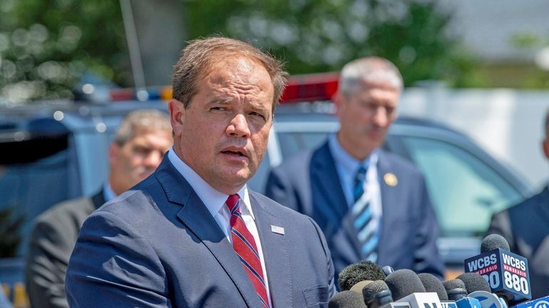 Suffolk County District Attorney Ray Tierney addresses the media outside...