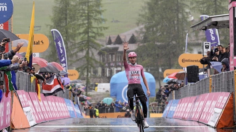 Slovenia's Tadej Pogacar, wearing the pink jersey of the race...