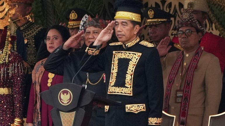 Indonesian President Joko Widodo, center, and Defense Minister and president-elect...