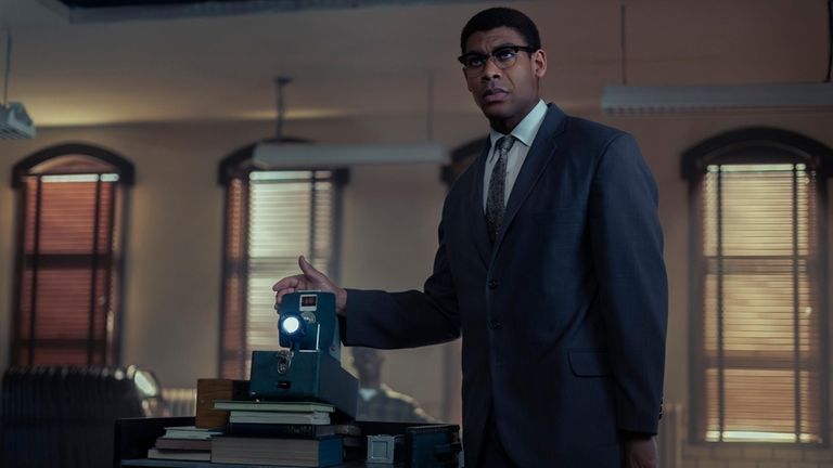 Malcolm X, played by Aaron Pierre, reviews slides in "Genius:...