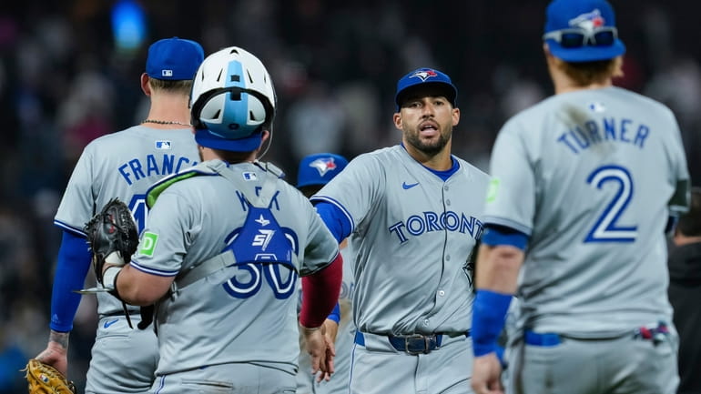 Toronto Blue Jays' George Springer, center, celebrates with teammates after...