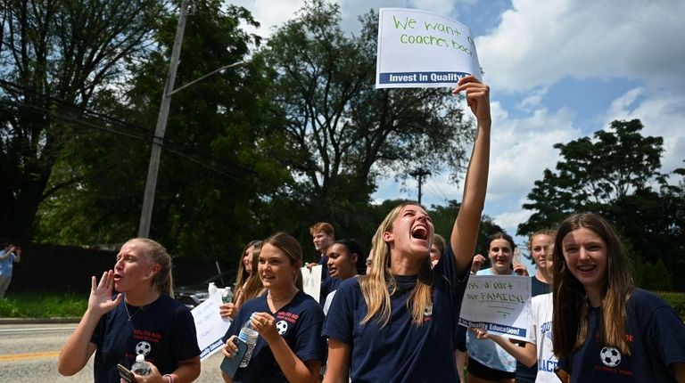 Anna Pennecke, 17, holding sign at center, with other members...