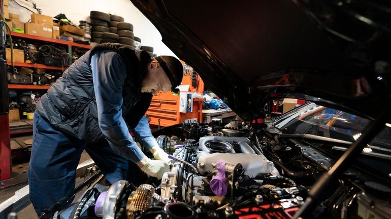 File - Mechanic David Stoliaruk works on the engine of...