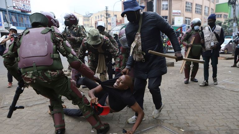 A protester is arrested in Nairobi, Kenya, Thursday Aug. 8,...