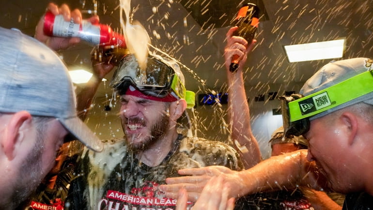 The Texas Rangers celebrate after Game 7 of the baseball...